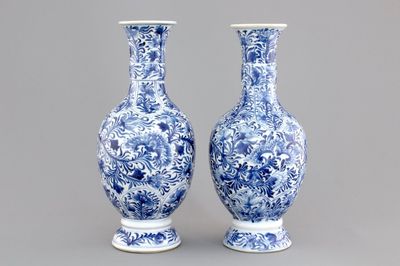 A pair of Chinese porcelain blue and white flower scroll vases, Kangxi, ca. 1700