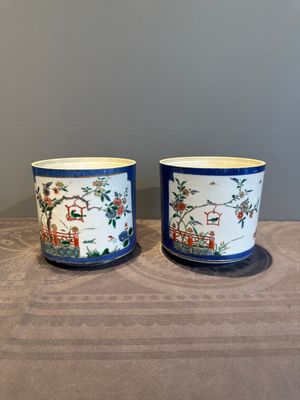 A pair of Chinese powder blue-ground famille verte vessels with a bird in a garden, Kangxi — photo 1