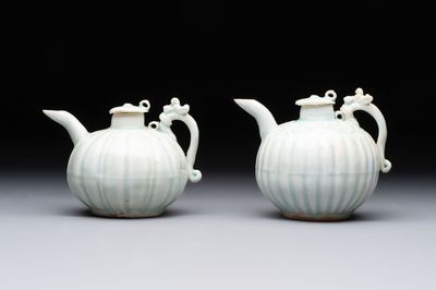 A pair of Chinese qingbai ewers and covers with dragon-form handles, Song/Yuan