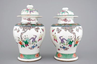 A pair of Chinese vases with covers with playing boys, 19th C.
