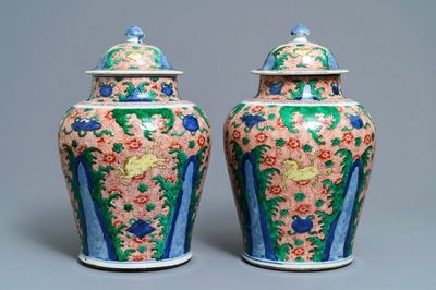 A pair of Chinese wucai 'galloping horses' vases and covers, Transitional period