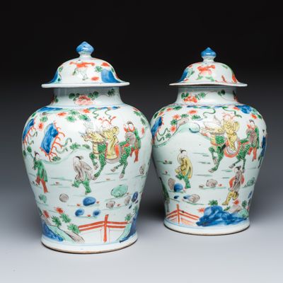 A pair of Chinese wucai 'Qi Lin Song Zi 麒麟送子' vases and covers, Transitional period