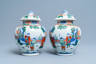 A pair of Chinese wucai vases and covers, Kangxi mark, 19th C.
