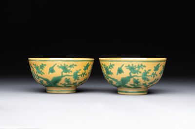 A pair of Chinese yellow-ground 'peach and bird' bowls, Qianlong mark and probably of the period