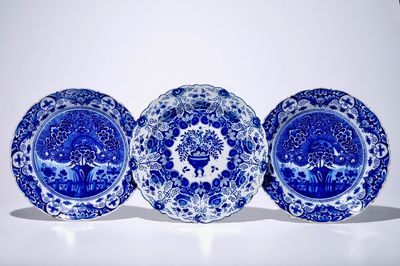 A pair of Dutch Delft blue and white "Tea Tree" dishes and a dish with a flower basket, 18th C.