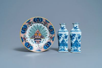 A pair of Dutch Delft blue and white vases and a 'peacock's tail' plate, 18th C.