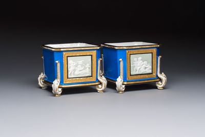 A pair of French gilt blue-ground 'Cherub' jardinières with biscuit-relief plaques, 19/20th C.