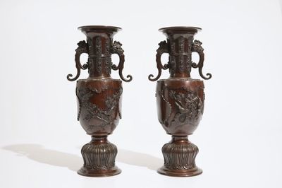 A pair of Japanese bronze relief-decorated vases, Meiji, 19th C.