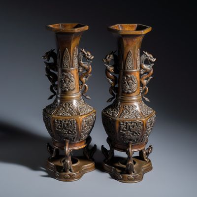 A pair of Japanese bronze vases with dragon-form handles, Dai Nihon Takaoka shi Kakuha sei 大日本高岡市角羽製 mark, Meiji, 19th C.