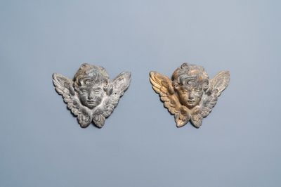 A pair of parcel-gilt lead winged cherub heads, 17th C.