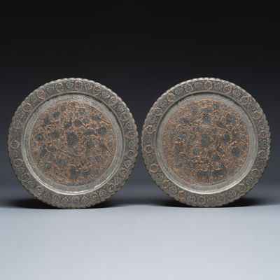 A pair of Persian engraved tinned-copper dishes with flowers and animals, 19/20th C.