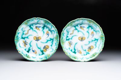 A pair of polychrome Brussels faience plates with butterflies and caterpillars, 18th C.