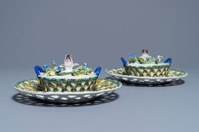 A pair of polychrome Dutch Delft butter tubs with applied design on reticulated stands, 18th C.