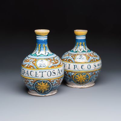 A pair of polychrome monogrammed Italian maiolica pharmacy bottles, probably workshop of Giacomo Mancini, 'El Frate', Deruta, ca. 1573