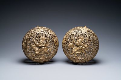A pair of reticulated Tibetan copper incense balls, 17/18th C.