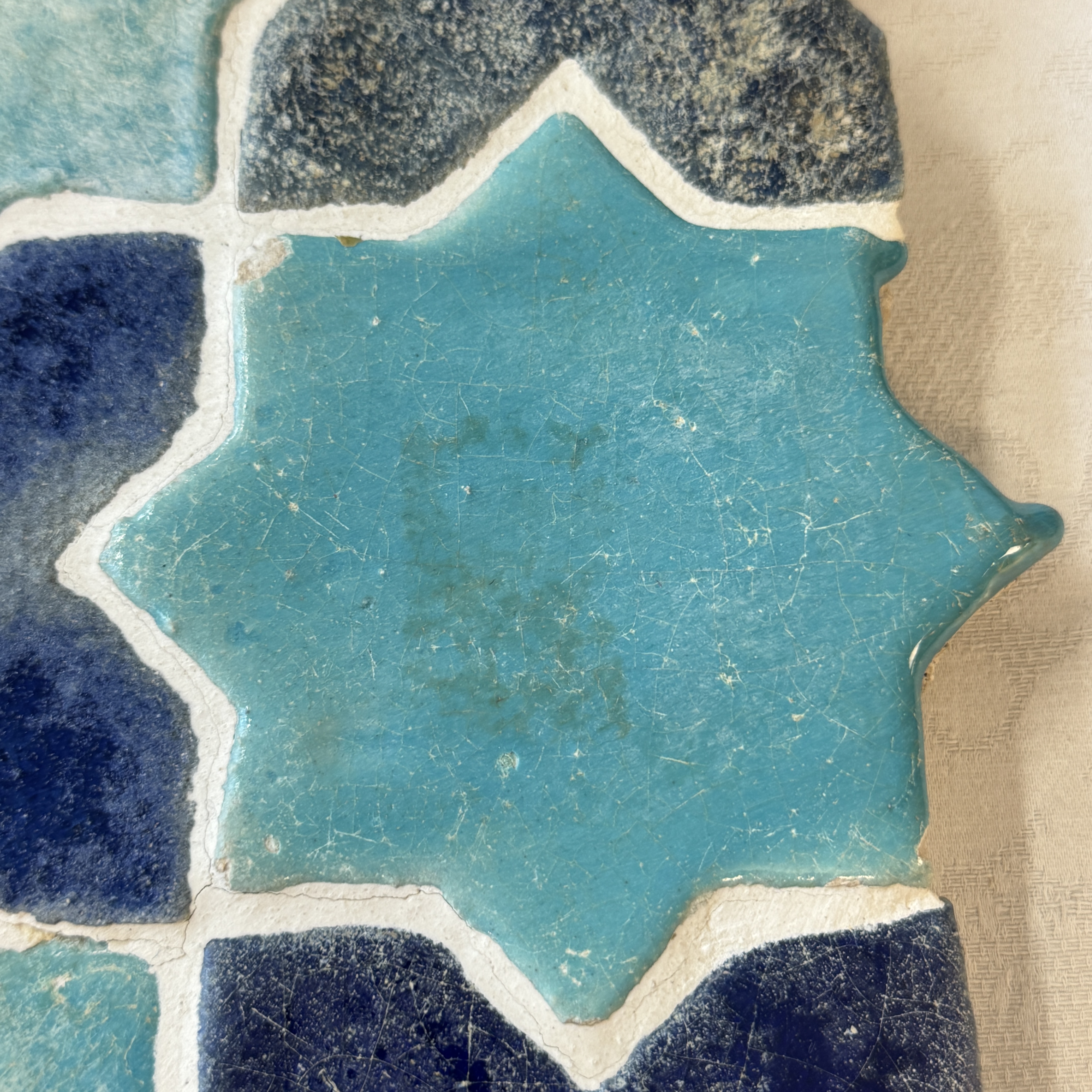 A panel of nine Kashan turquoise- and blue-glazed star and cross tiles — photo 9