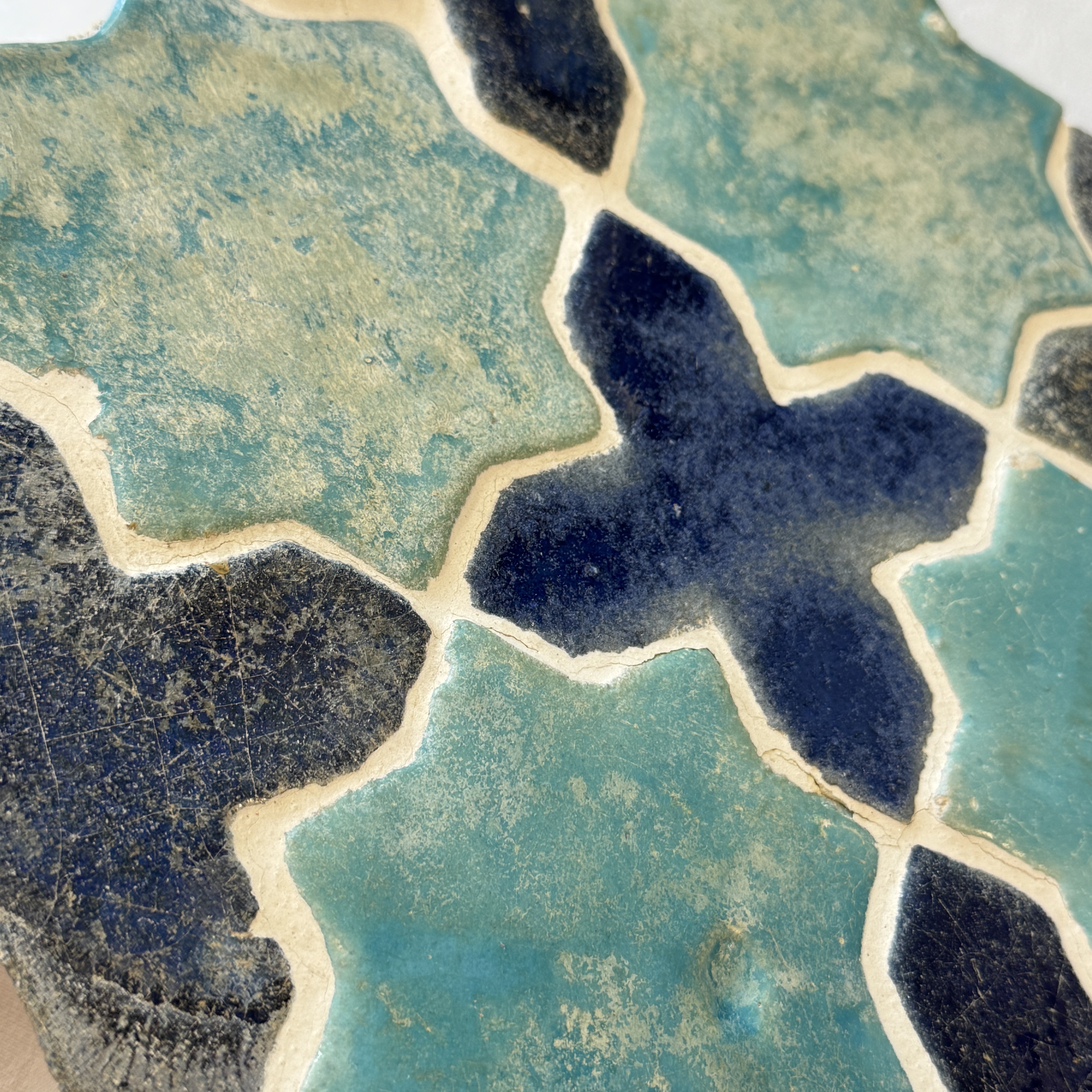 A panel of nine Kashan turquoise- and blue-glazed star and cross tiles — photo 10