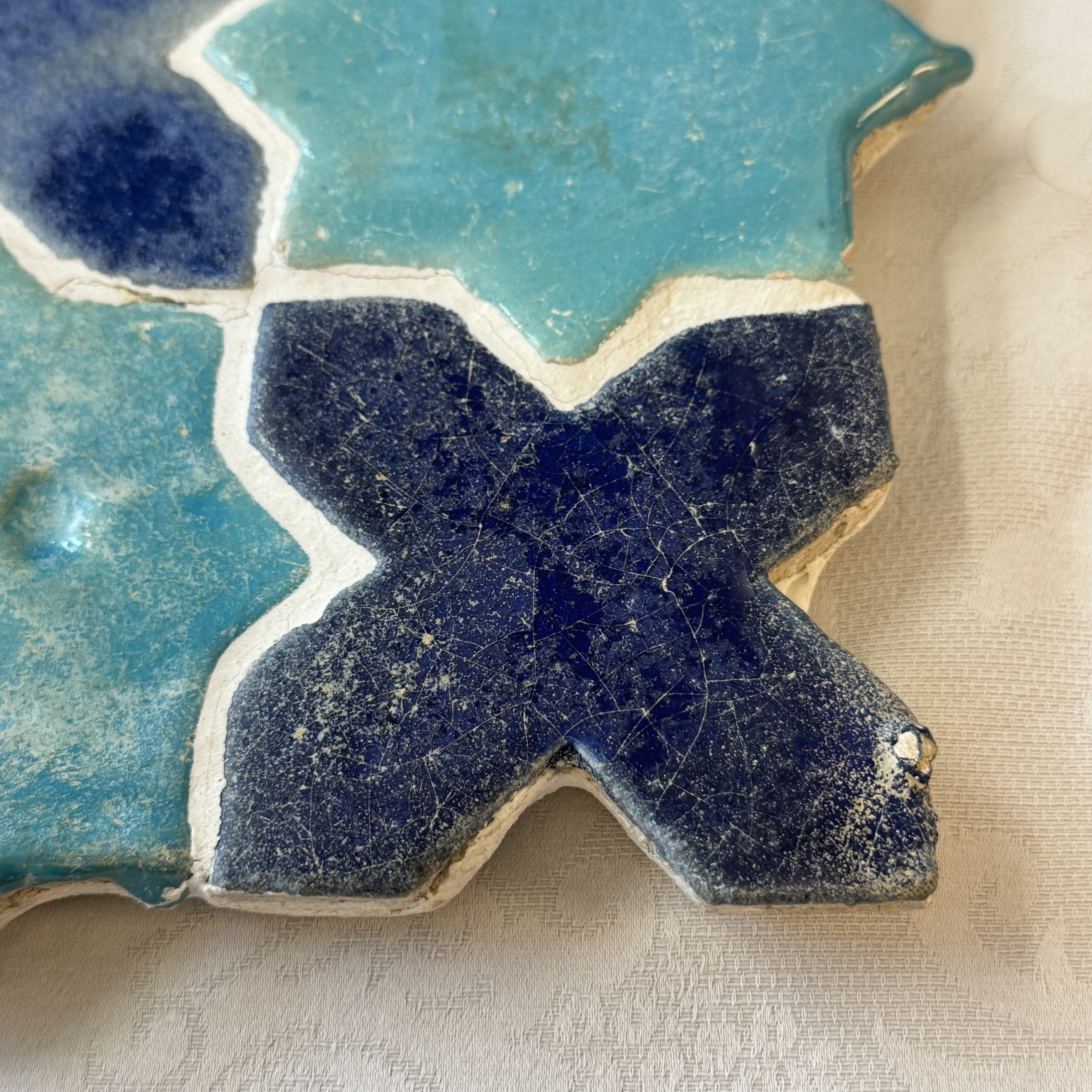A panel of nine Kashan turquoise- and blue-glazed star and cross tiles — photo 2