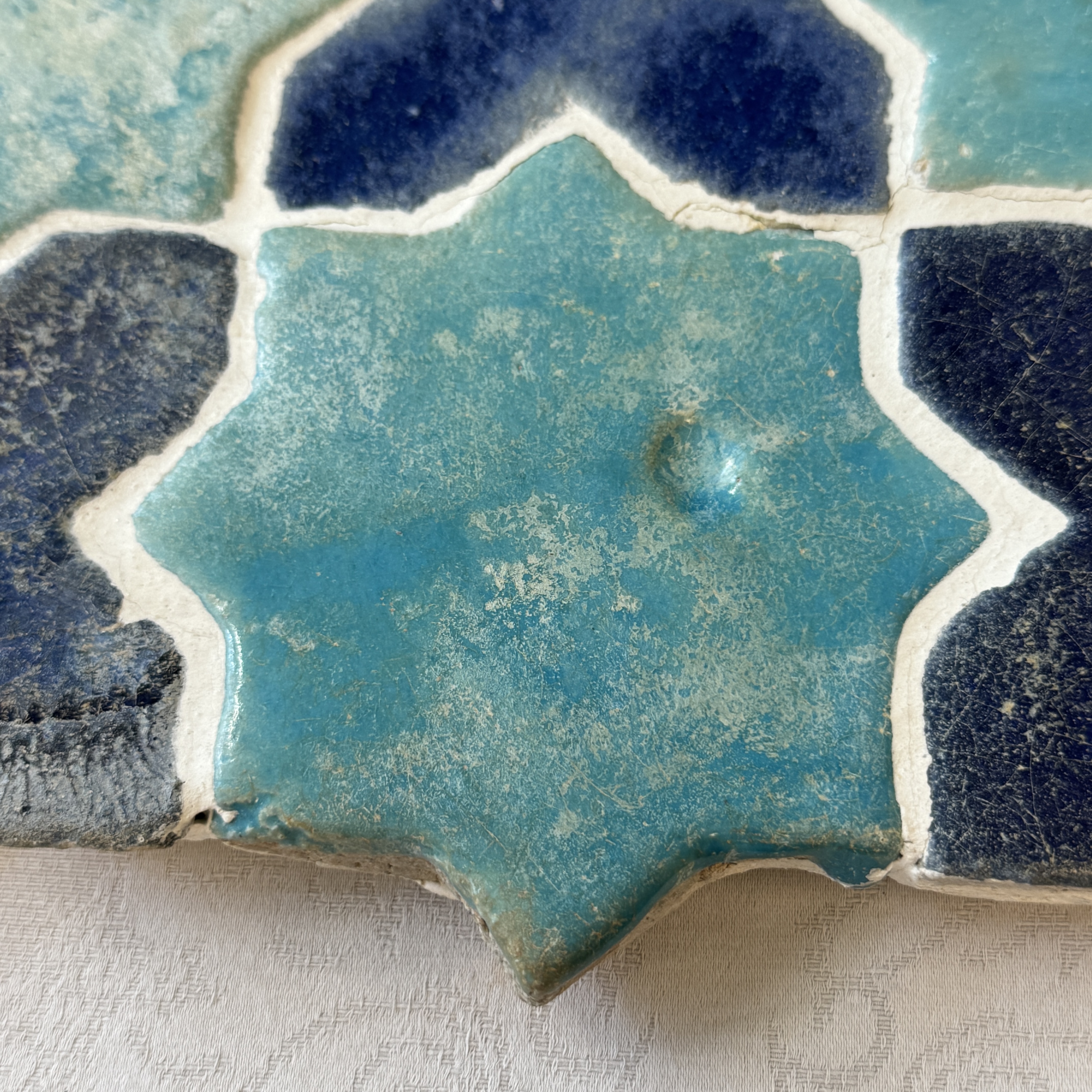 A panel of nine Kashan turquoise- and blue-glazed star and cross tiles — photo 3