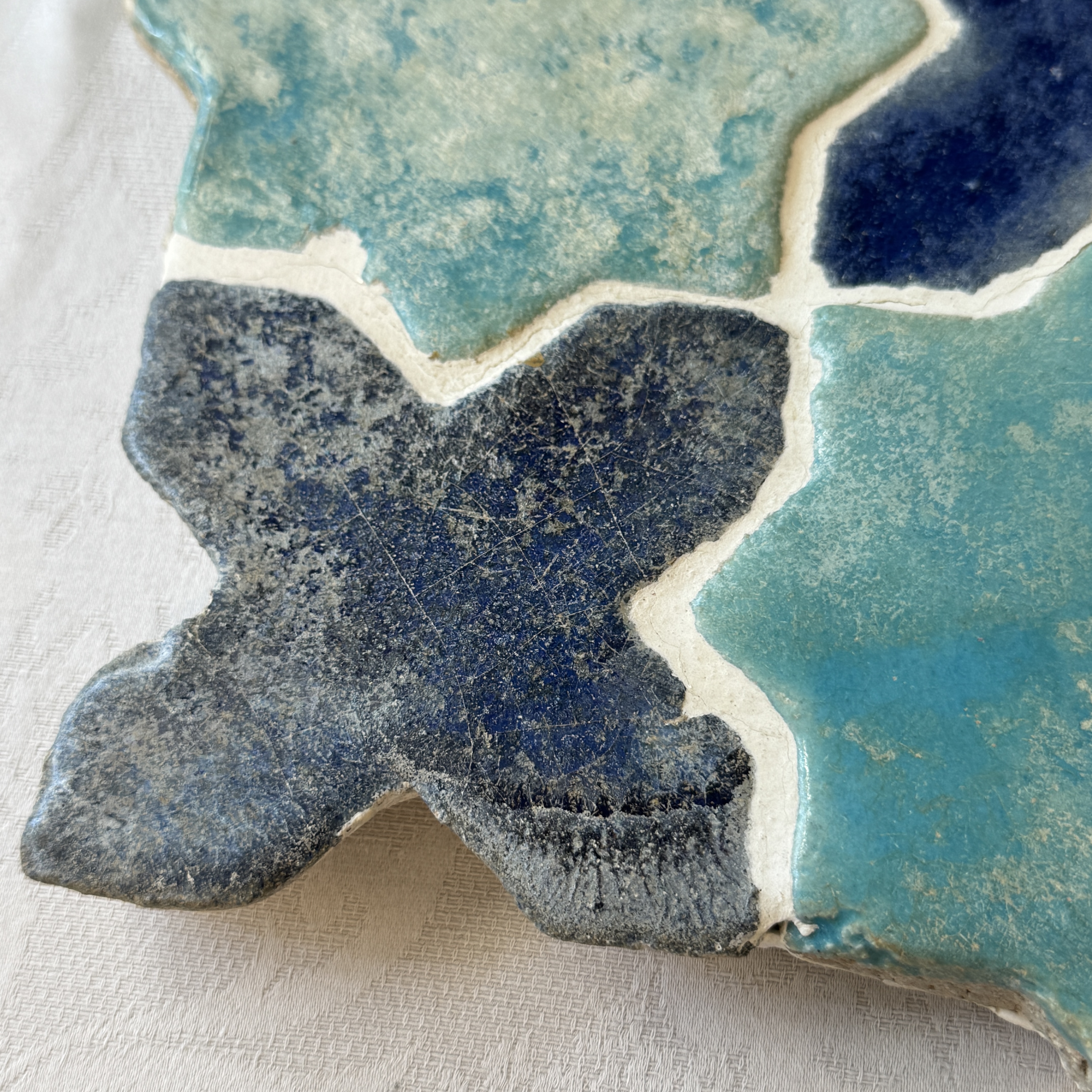 A panel of nine Kashan turquoise- and blue-glazed star and cross tiles — photo 4