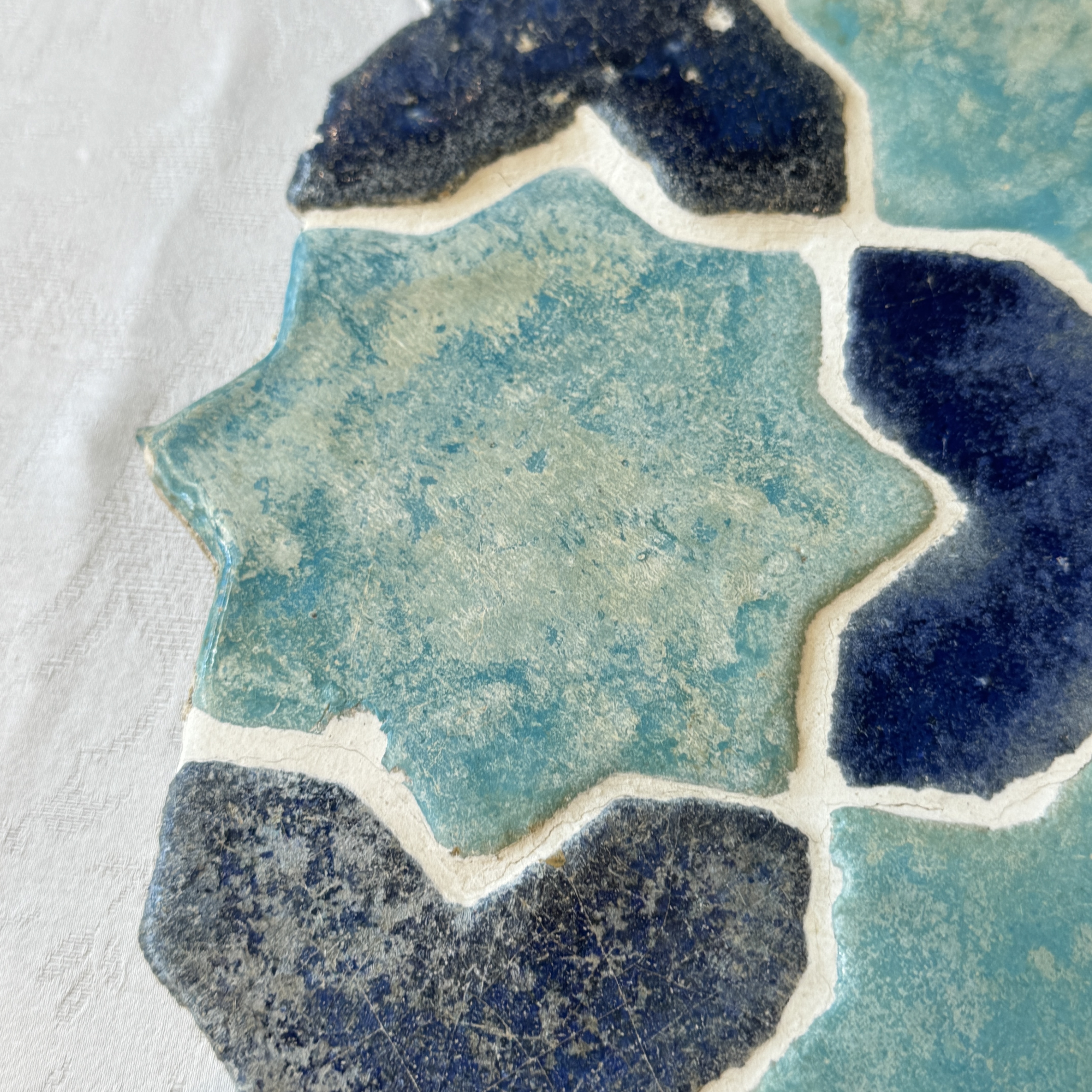 A panel of nine Kashan turquoise- and blue-glazed star and cross tiles — photo 5