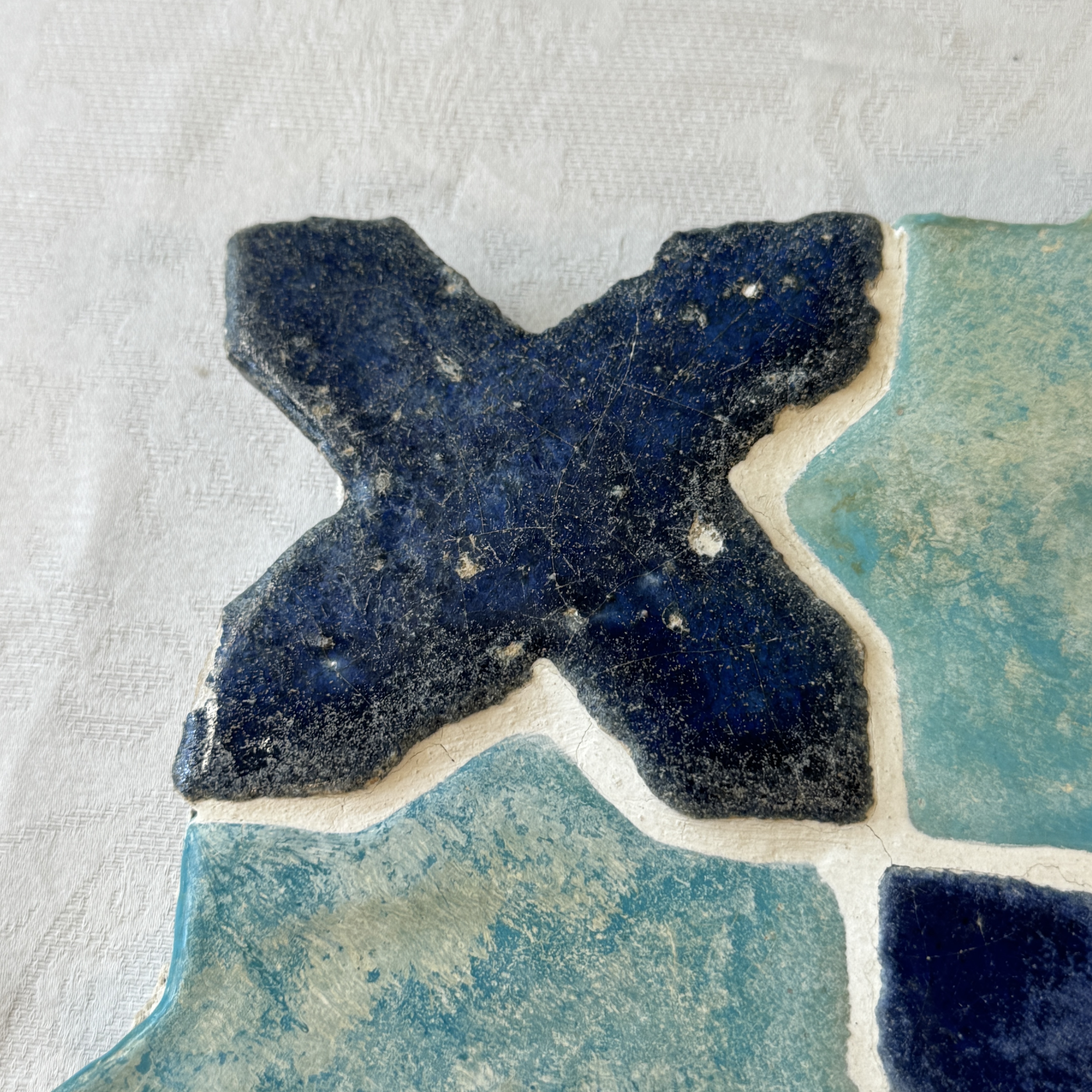 A panel of nine Kashan turquoise- and blue-glazed star and cross tiles — photo 6