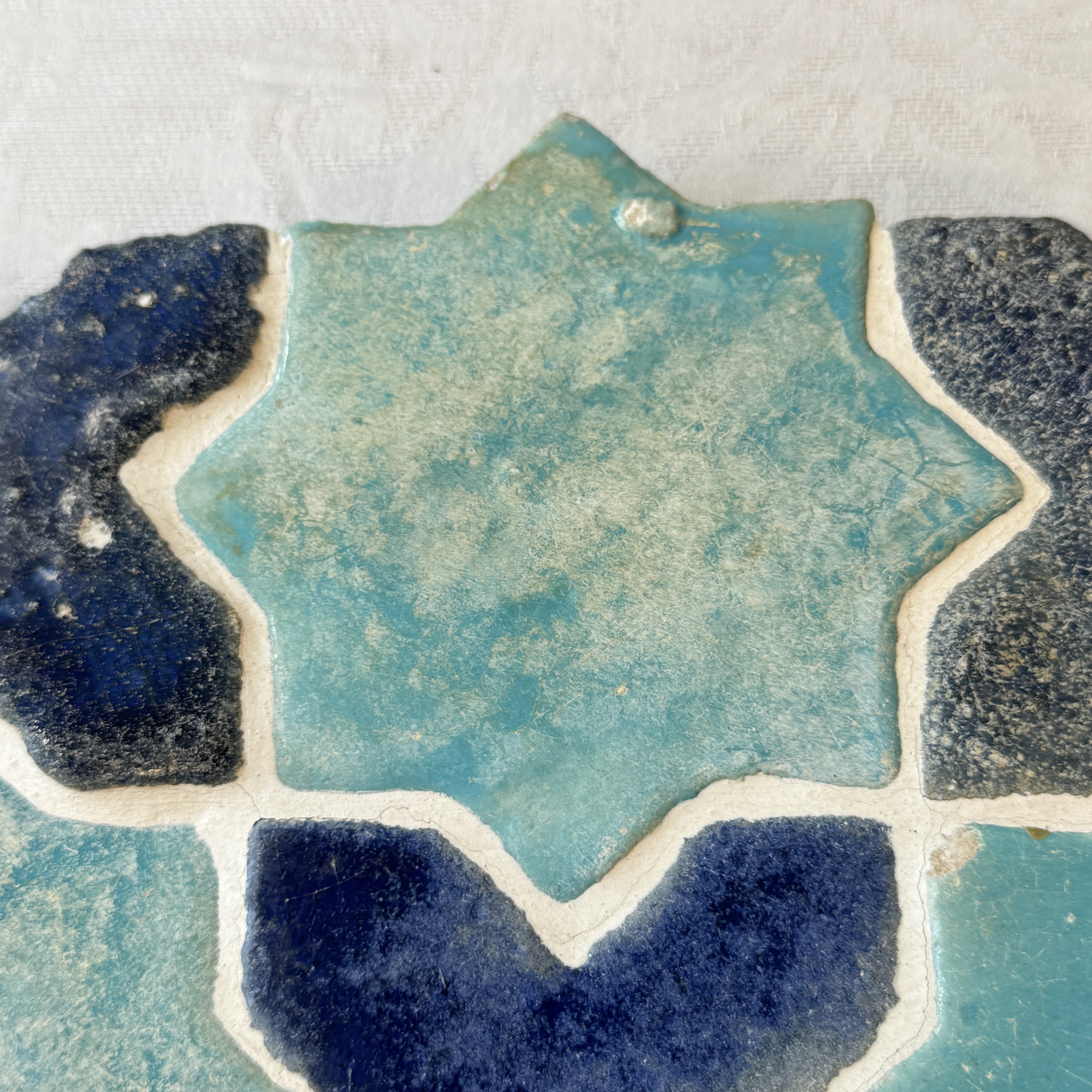 A panel of nine Kashan turquoise- and blue-glazed star and cross tiles — photo 7