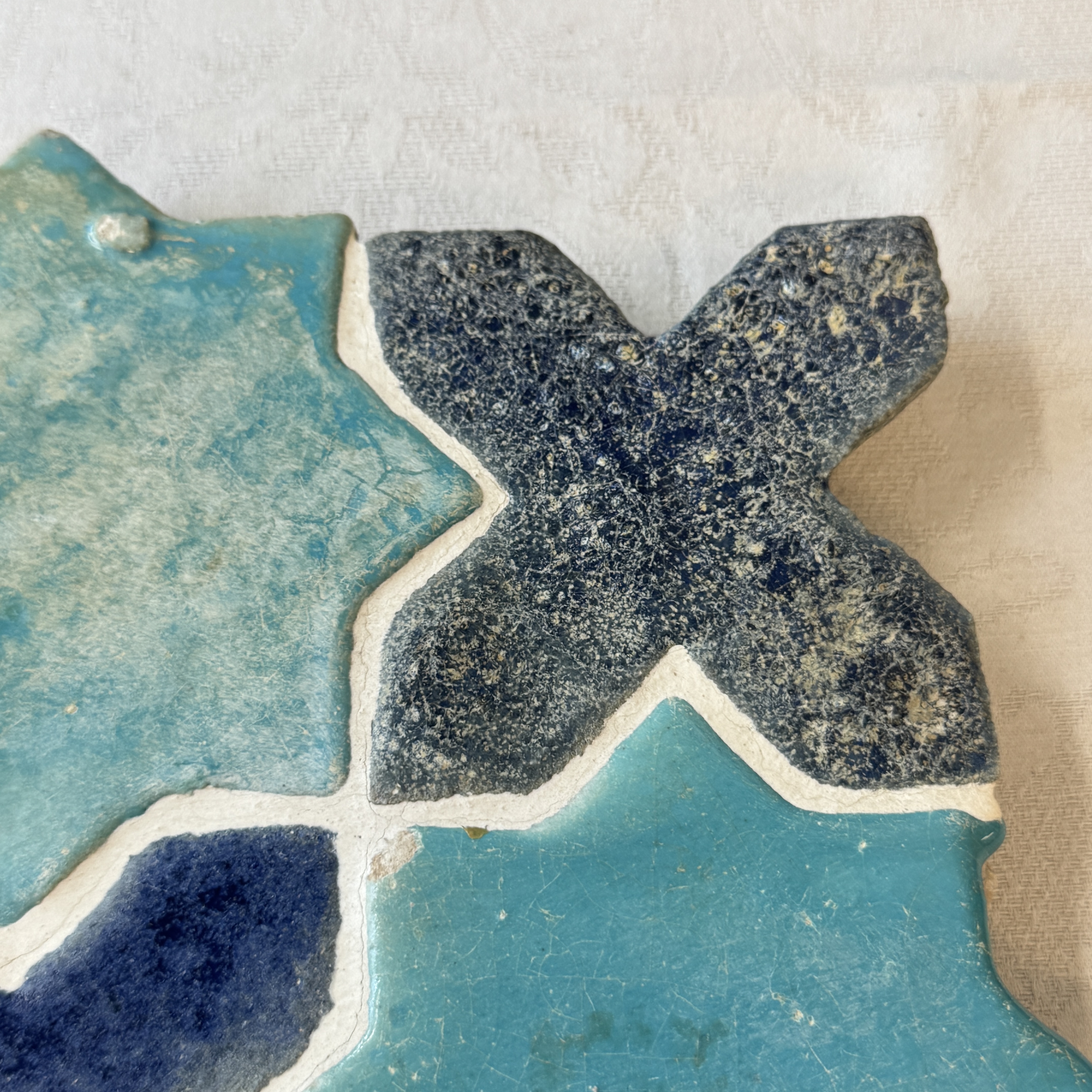 A panel of nine Kashan turquoise- and blue-glazed star and cross tiles — photo 8