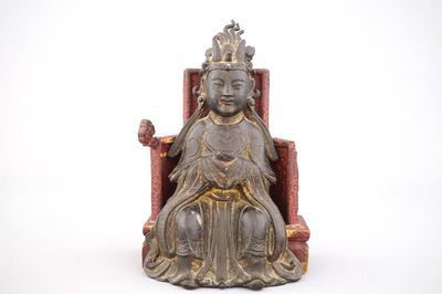 A partly gilt bronze model of a Guanyin, seated on a lacquered wood throne, Ming dynasty