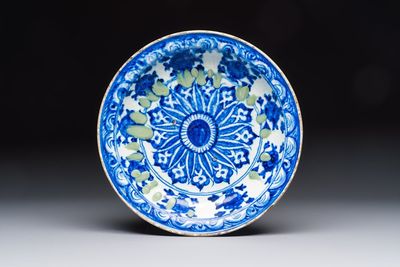 A Persian blue, white, and green glazed dish with stylised floral design, Safavid, 17/18th C.