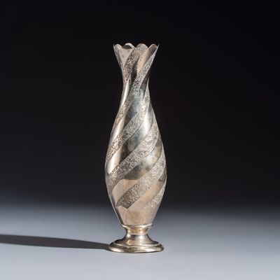 A Persian or Iranian silver vase with twisted floral design, 19/20th C.
