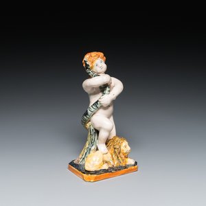 A polychrome Brussels faience sculpture of a putto with a snake standing on a lion, late 18th C. — 照片 1