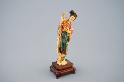 A polychrome Chinese carved ivory figure of Guanyin on wood base, 19th C.