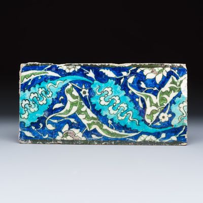 A polychrome Damascus pottery border tile with floral design, 16th C.