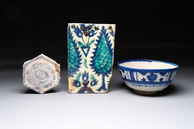 A polychrome Damascus tile, a Persian hexagonal tile and a blue-glazed bowl, 17/19th C.