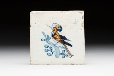 A polychrome Dutch Delft 'bird on a branch' tile, 17th C.
