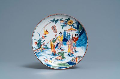 A polychrome Dutch Delft chinoiserie plate with figures in a garden, 18th C.