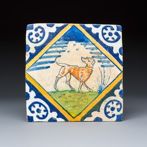 A polychrome Dutch Delft 'diamond' tile with a dog and four framed blue and white tiles — photo 2