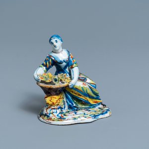 A polychrome Dutch Delft figure of a lady selling flowers, 18th C. — 照片 1