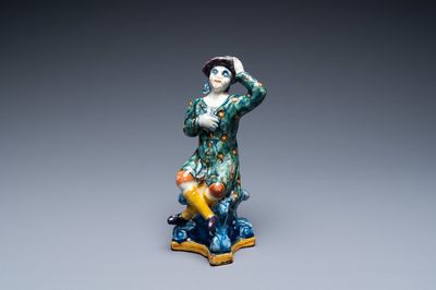 A polychrome Dutch Delft figure of a seated man, 18th C.