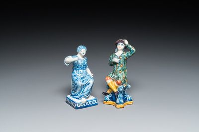 A polychrome Dutch Delft figure of a seated man and a blue and white one of a seated lady, 18th C.
