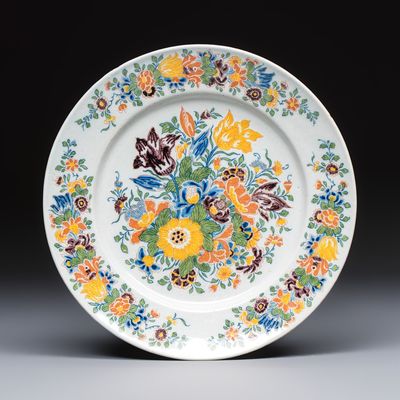A polychrome Dutch Delft plate with floral design, ca. 1740-60