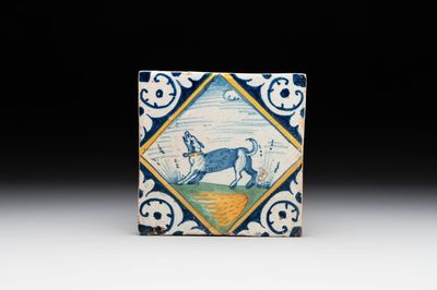 A polychrome Dutch Delft maiolica 'diamond' 'dog' tile, late 16th C.