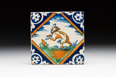 A polychrome Dutch Delft maiolica 'dog' diamond tile, late 16th C.