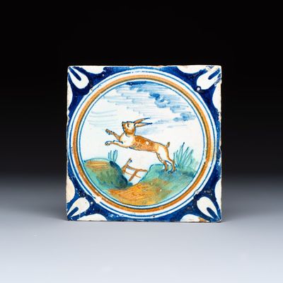 A polychrome Dutch Delft maiolica medallion tile with a leaping hare, 16th C.