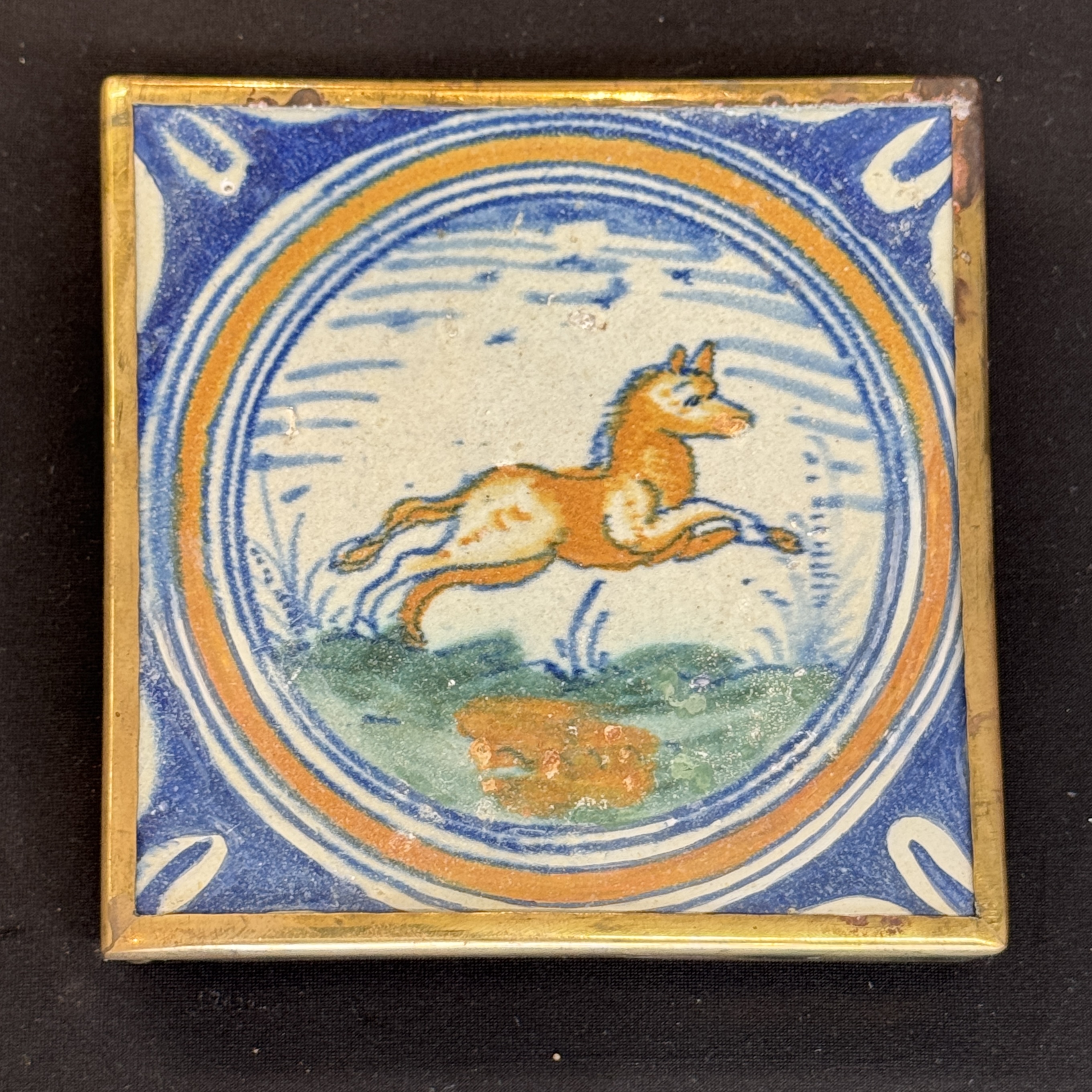 A polychrome Dutch Delft maiolica medallion tile with a leaping horse — photo 12