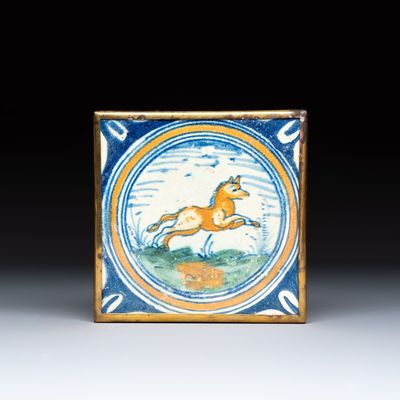 A polychrome Dutch Delft maiolica medallion tile with a leaping horse, 16th C.