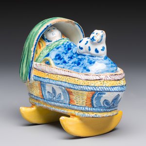 A polychrome Dutch Delft model of a child in a cradle with a cat — photo 1