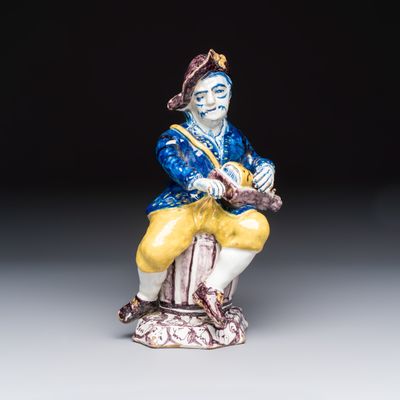 A polychrome Dutch Delft model of a hurdy-gurdy player, 18th C.