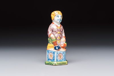 A polychrome Dutch Delft model of a seated oriental figure, 18th C.